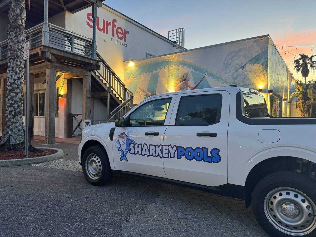 Sharkey Pools hybrid Ford Maverick service truck parked in Jacksonville Beach